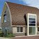 A single-family house covered with shaded copper brown Flandern tiles