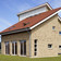 A single-family house covered with red engobed Flandern tiles