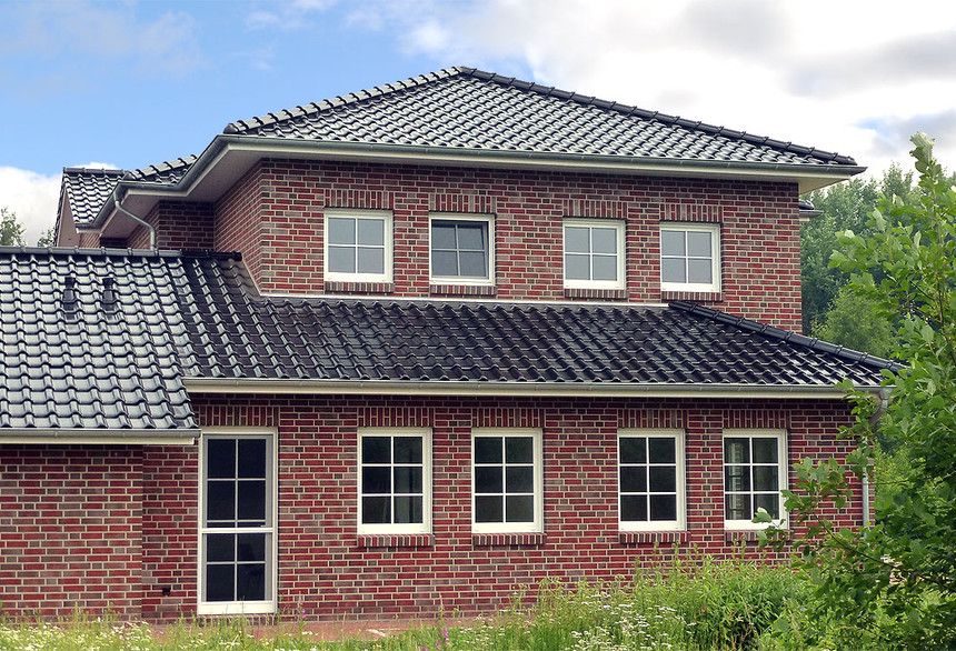 A single-family house covered with shaded black matte