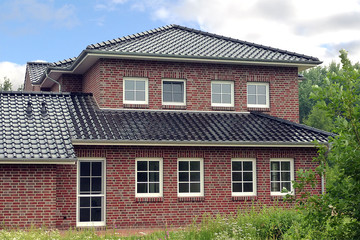 A single-family house covered with shaded black matte
