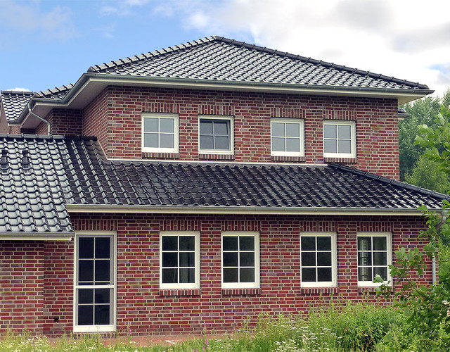 A single-family house covered with shaded black matte