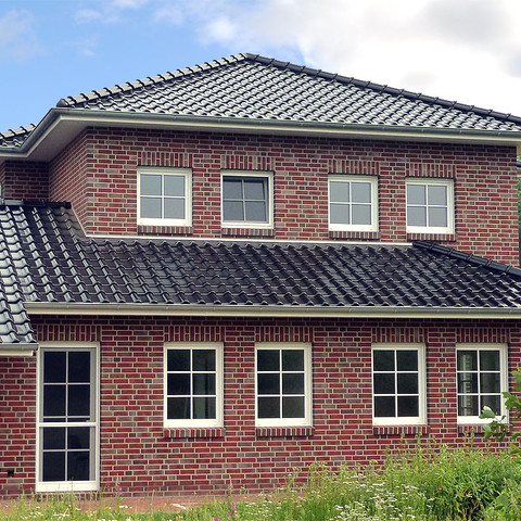 A single-family house covered with shaded black matte